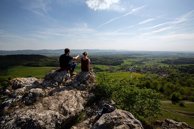 Zwei Menschen blicken von der Spielburg hinab ins Tal