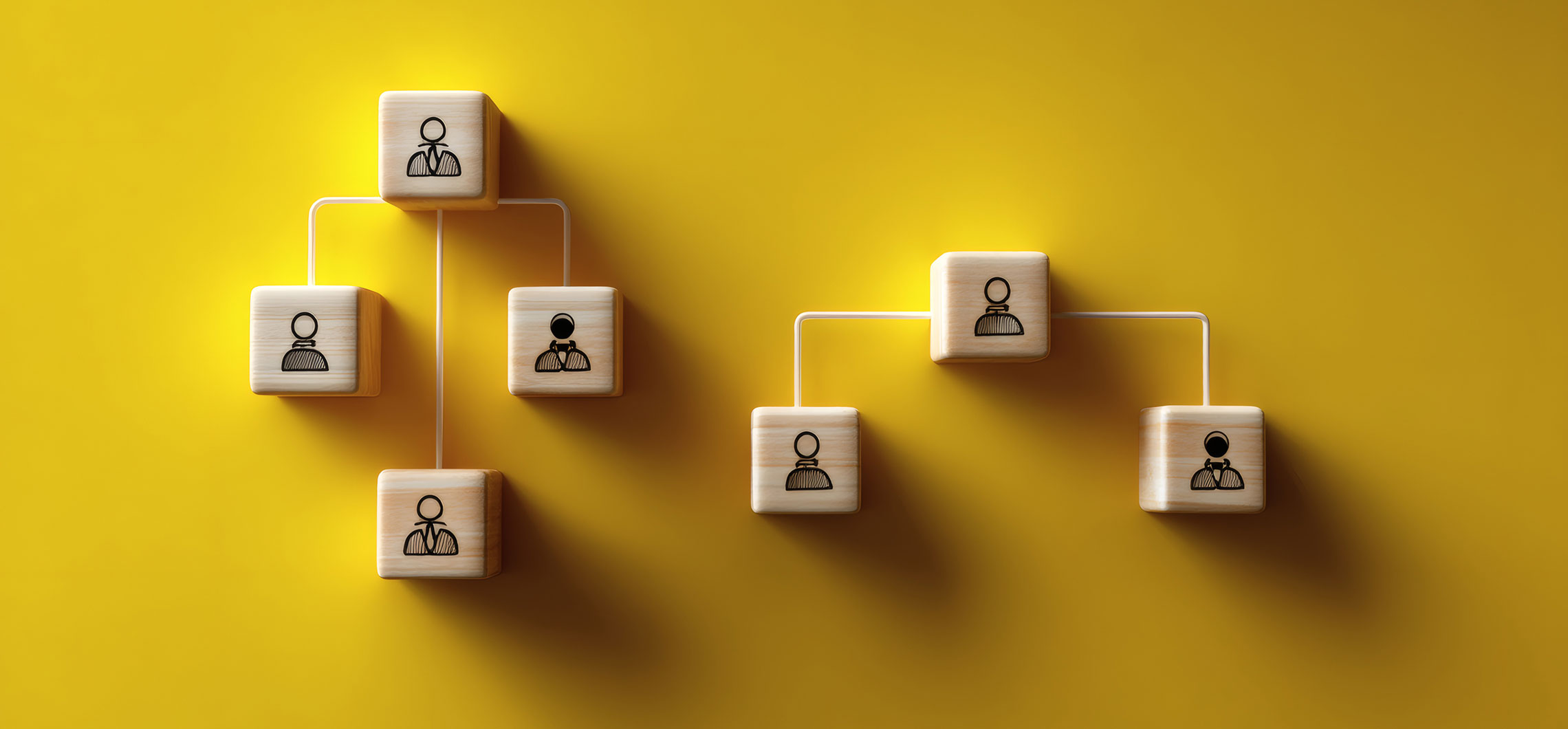 Mehrere bedruckte Holzsteine sind mit Linien miteinander verbunden und stehen symbolisch für Zusammenarbeit